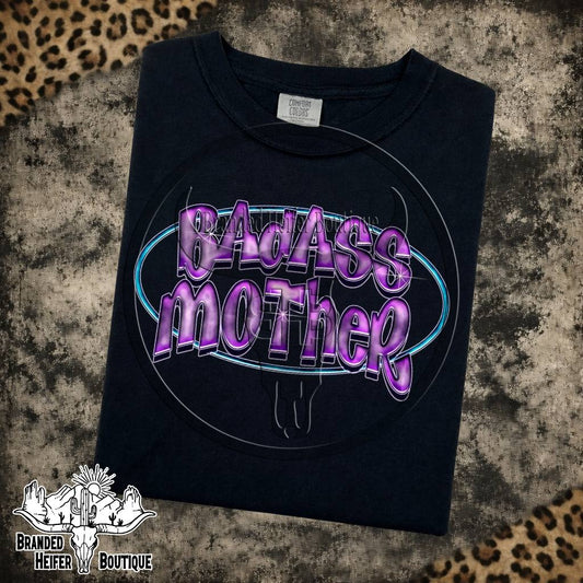 Badass Mother Neon Graphic Tee in Black, purple chrome Badass Mother lettering in a neon blue oval, printed on a Comfort Colors tee