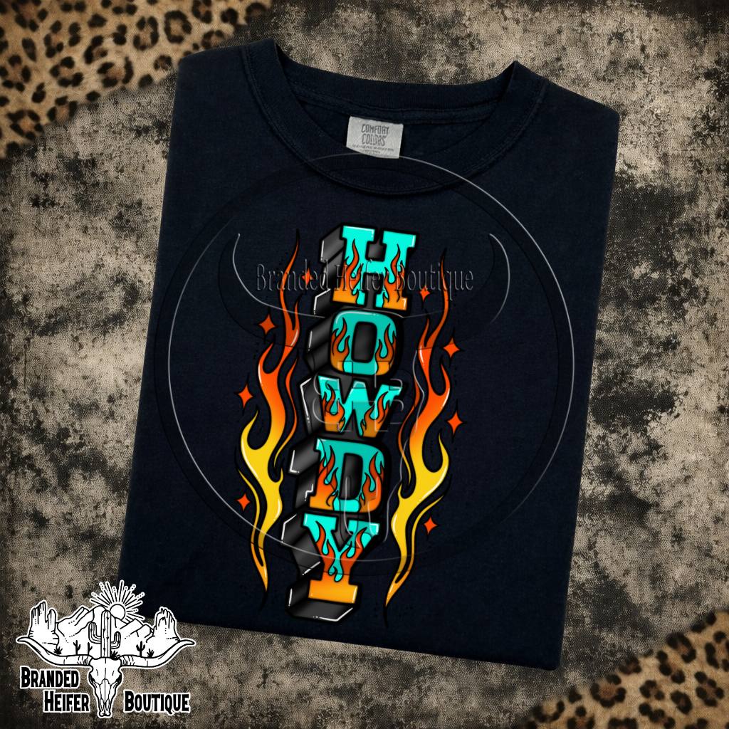 Howdy Flames Graphic Tee in Black, turquoise Howdy letters surrounded by tattoo style flames, printed on a Comfort Colors tee