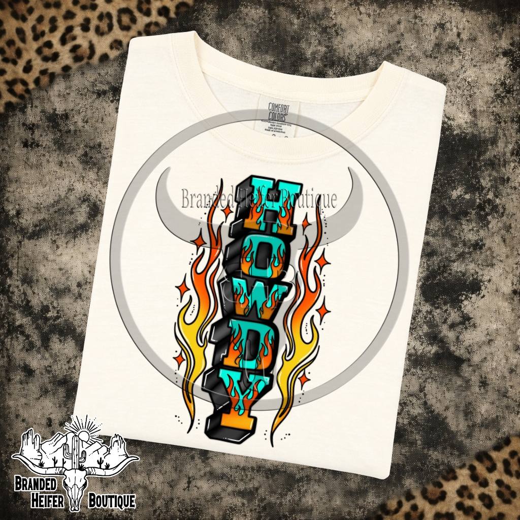 Howdy Flames Graphic Tee in Ivory, turquoise Howdy letters surrounded by tattoo style flames, printed on a Comfort Colors tee